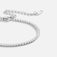 Cordelia Silver Tennis Bracelet, laid flat on white, close-up of clear stones and extender chain