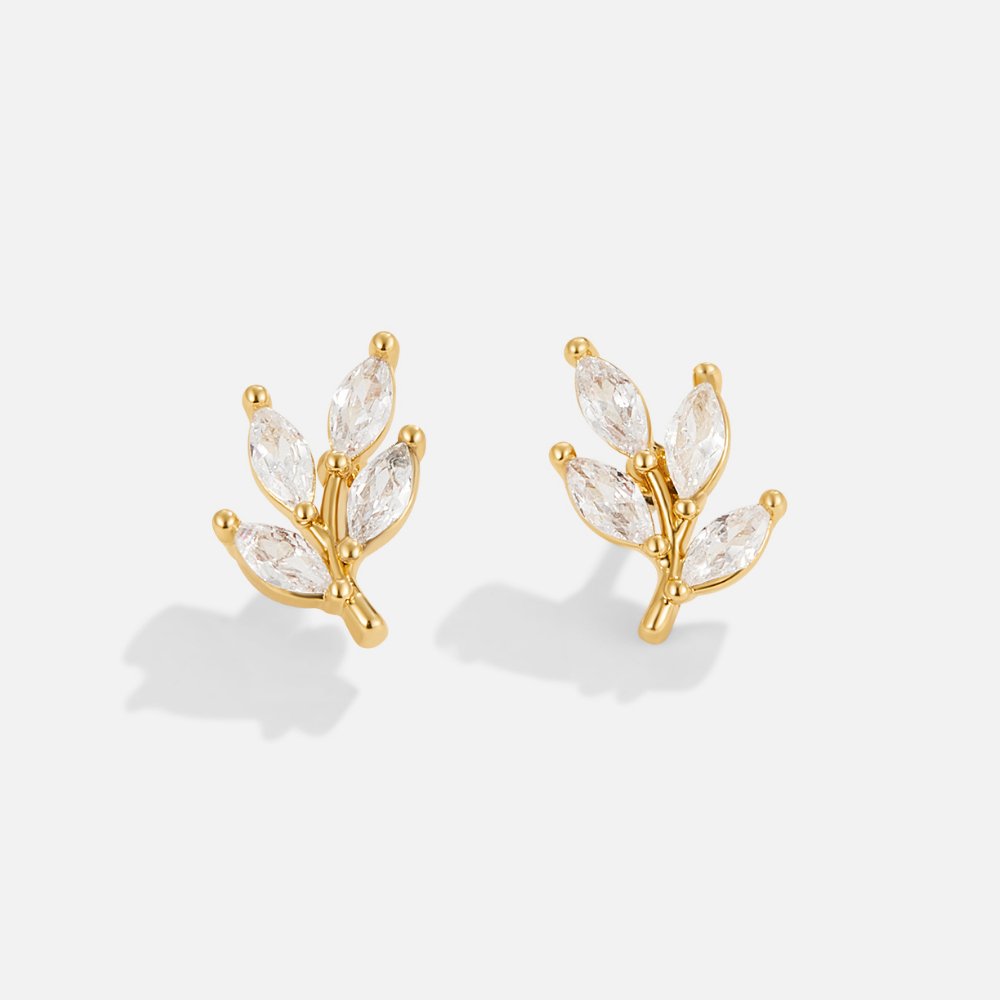 Crystal Leaf Stud Earrings, a pair of gold leaf earrings with clear marquise stones on white