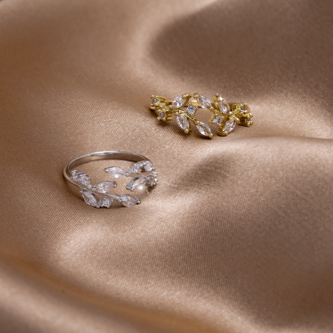 18K Gold Crystal Vine Ring, two rings lying on draped satin, one silver and one gold