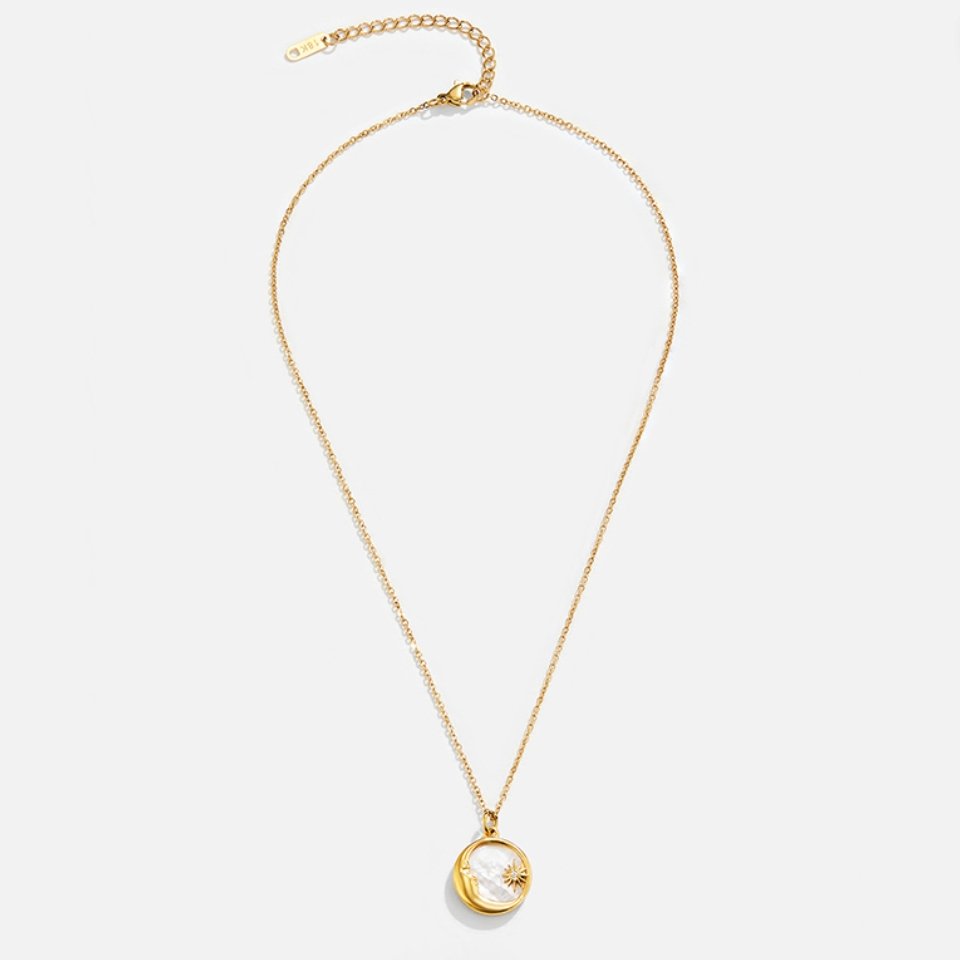 'Dreaming in the Clouds' Moon & Star Necklace, laid flat on a light grey background, full
