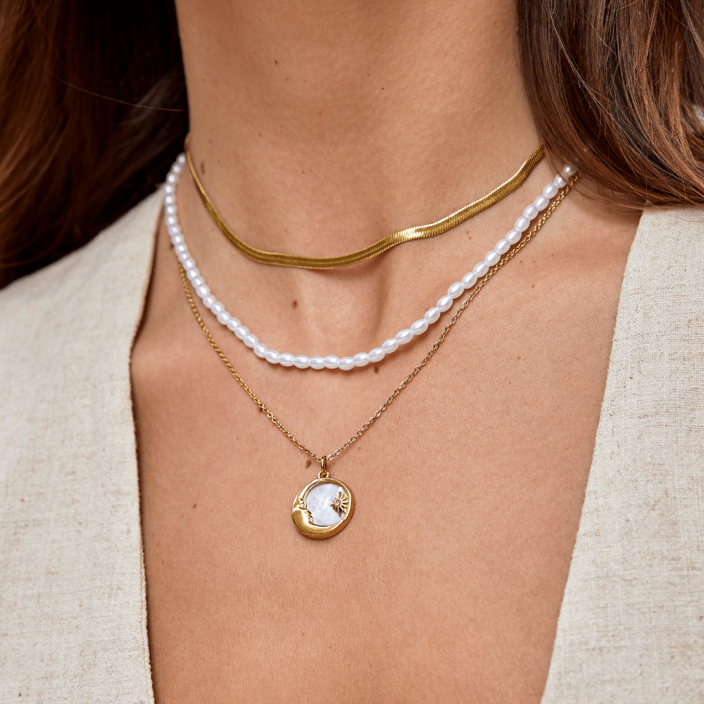 'Dreaming in the Clouds' Moon & Star Necklace, worn layered on a neck with a pearl strand and