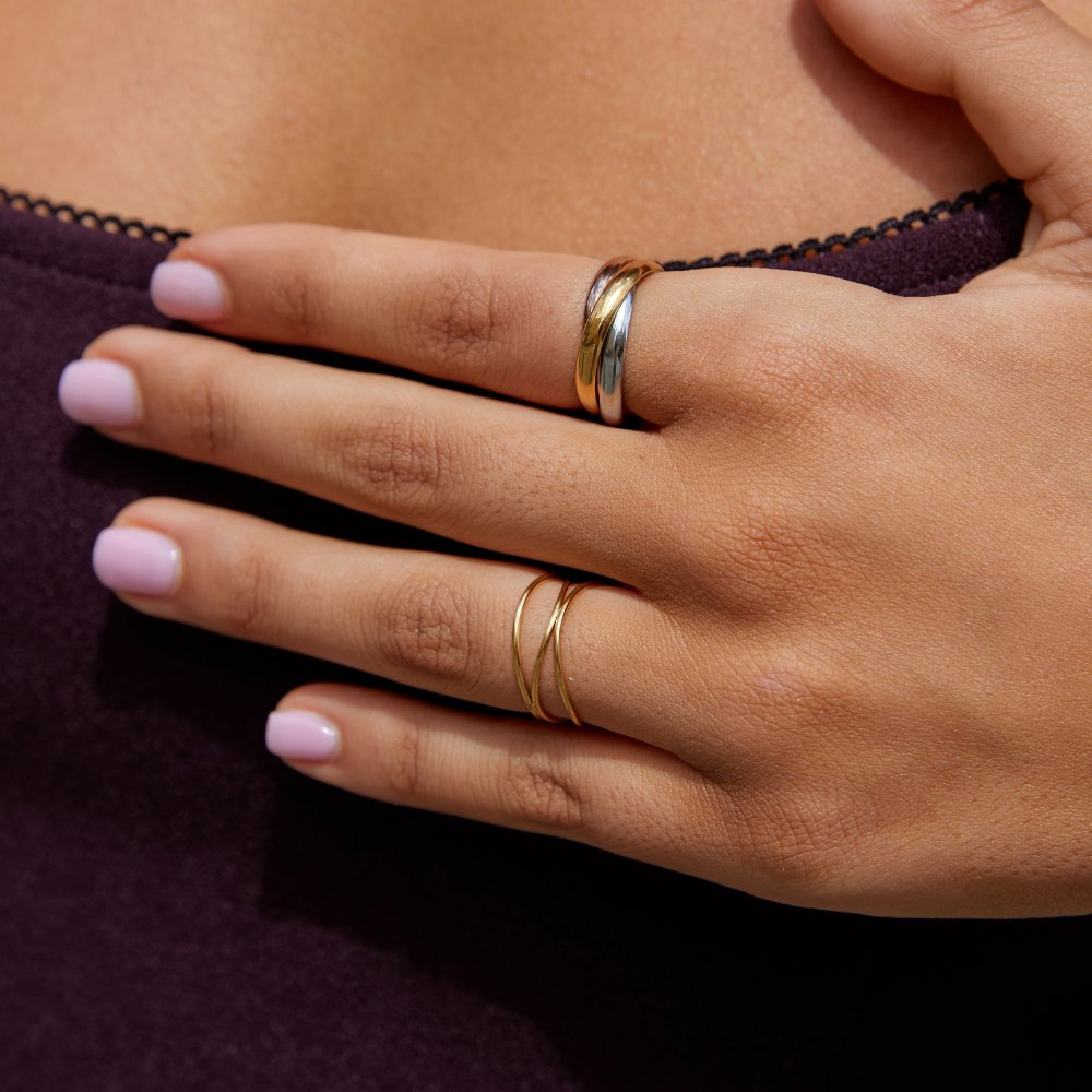 Elena Three-Toned Loop Ring, worn on a hand over a dark purple top, close-up
