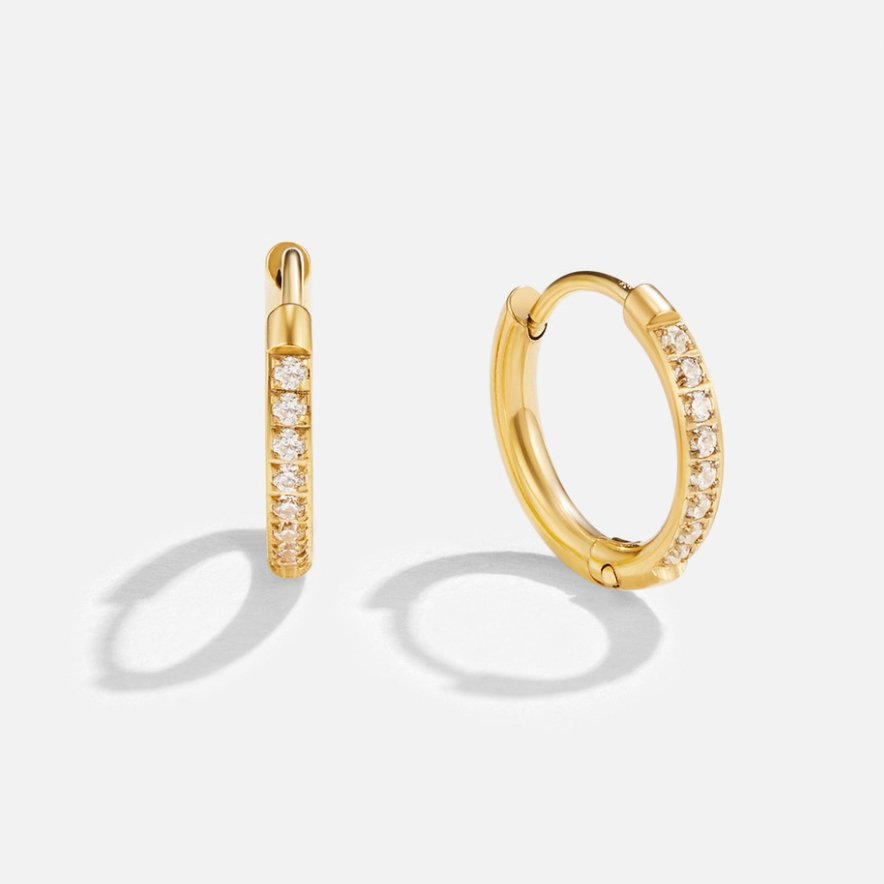 Eternity Hoop Earrings, pair of gold hoops with a row of small stones, standing upright on white