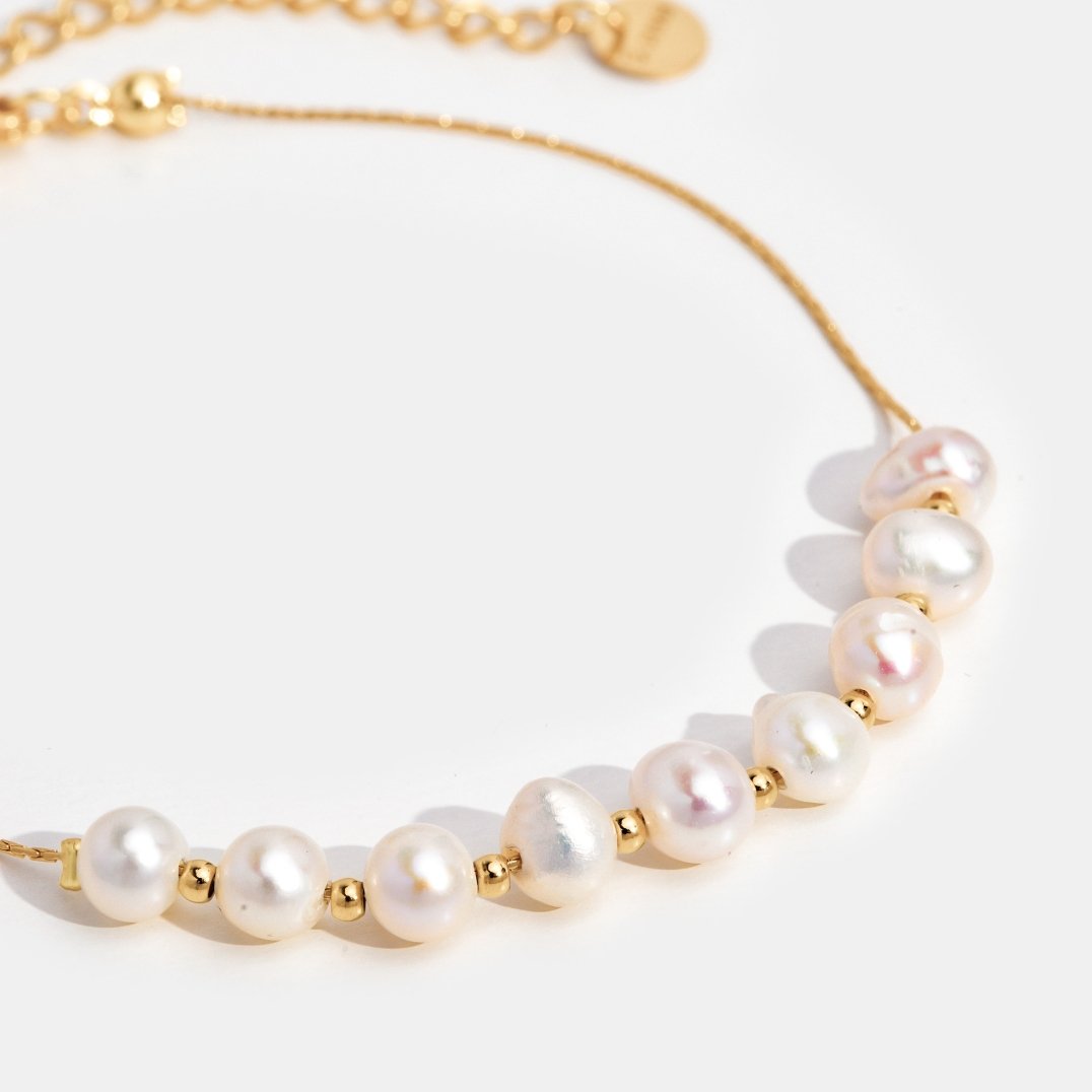 Eva Freshwater Pearl Bracelet, close-up of pearls and gold beads on a gold chain against white