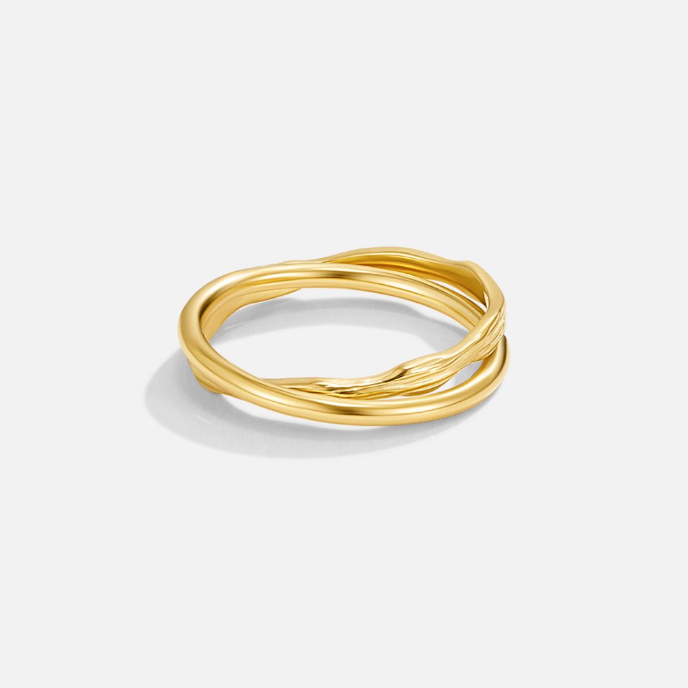 Forever Entwined Gold Ring, gold ring with two intertwined bands on a plain white background