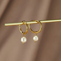 Freshwater Pearl Bella Hoop Earrings, pair of gold hoops with pearl drops, hung on a gold rod