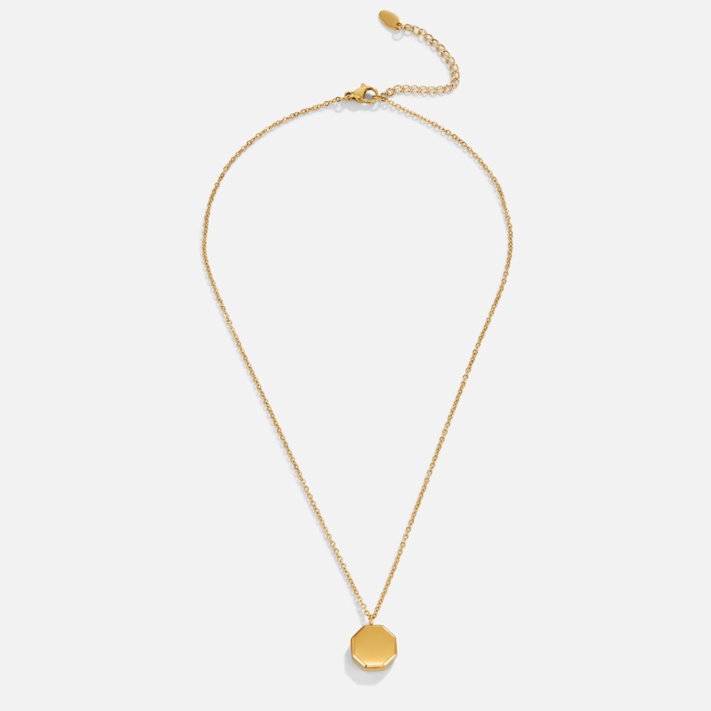 Geometric Pendant Necklace, flat lay of a gold chain with octagon pendant on white
