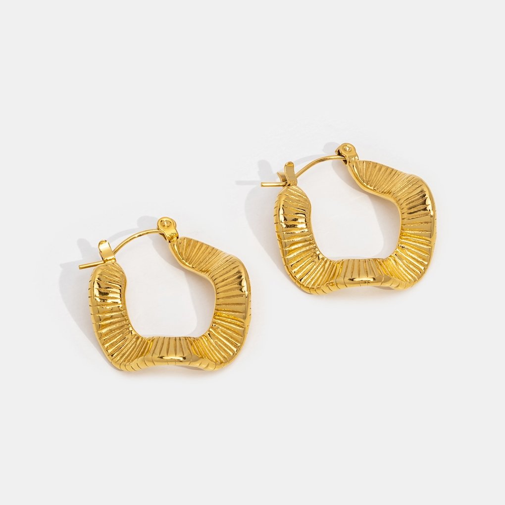 Geometric Wave Gold Hoop Earrings, pair of gold hoops on a white background, ridged wavy shape