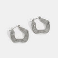 Geometric Wave Silver Hoop Earrings, a pair of silver hoops on a plain white background