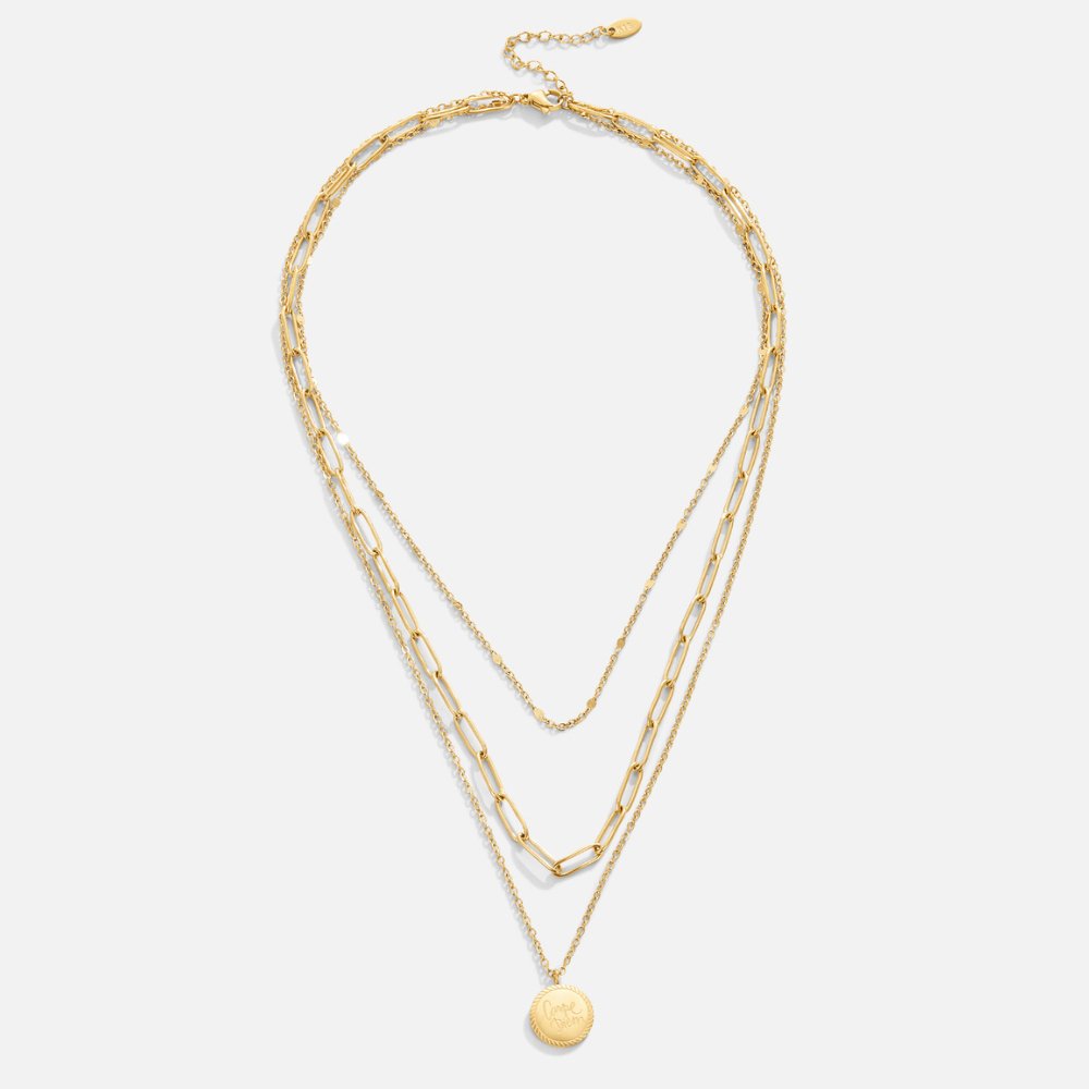 Geya Coin Layered Necklace, flat lay of three gold chains with a round coin pendant