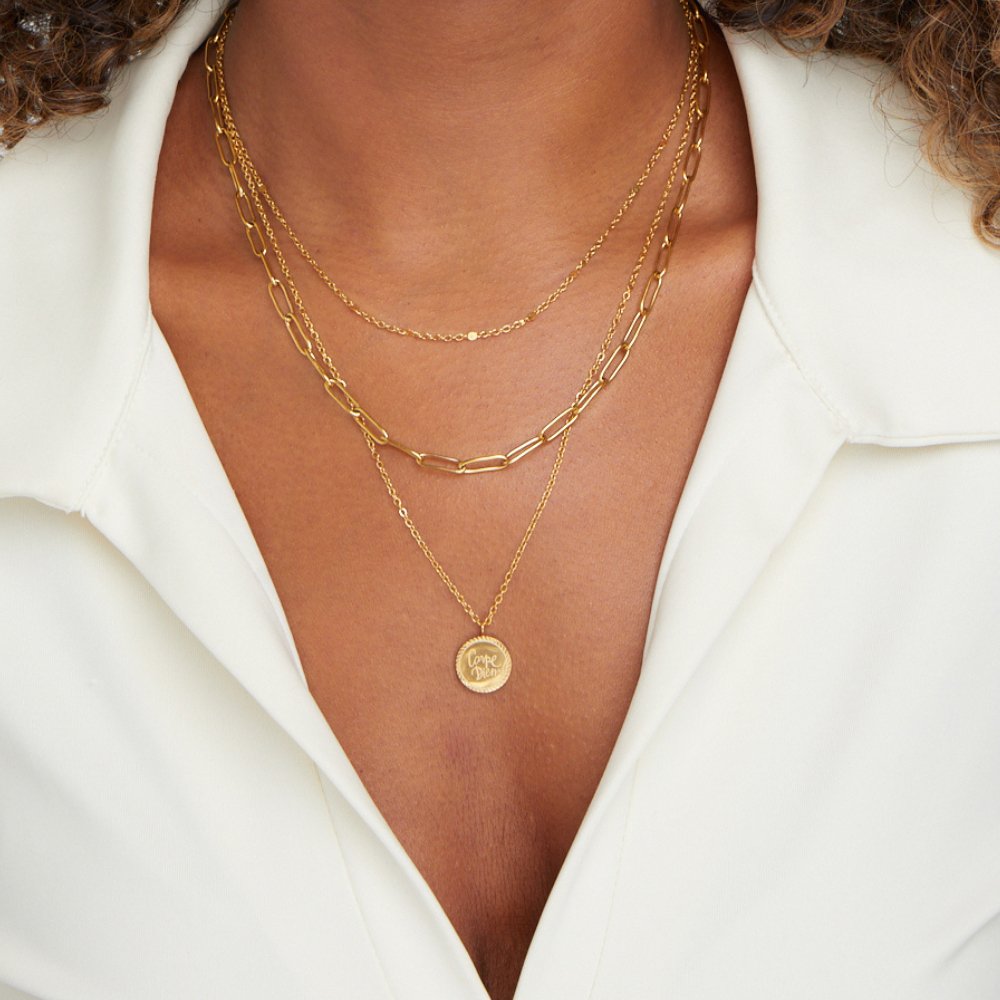 Geya Coin Layered Necklace, worn layered on a neck with a white open-collar shirt; round gold