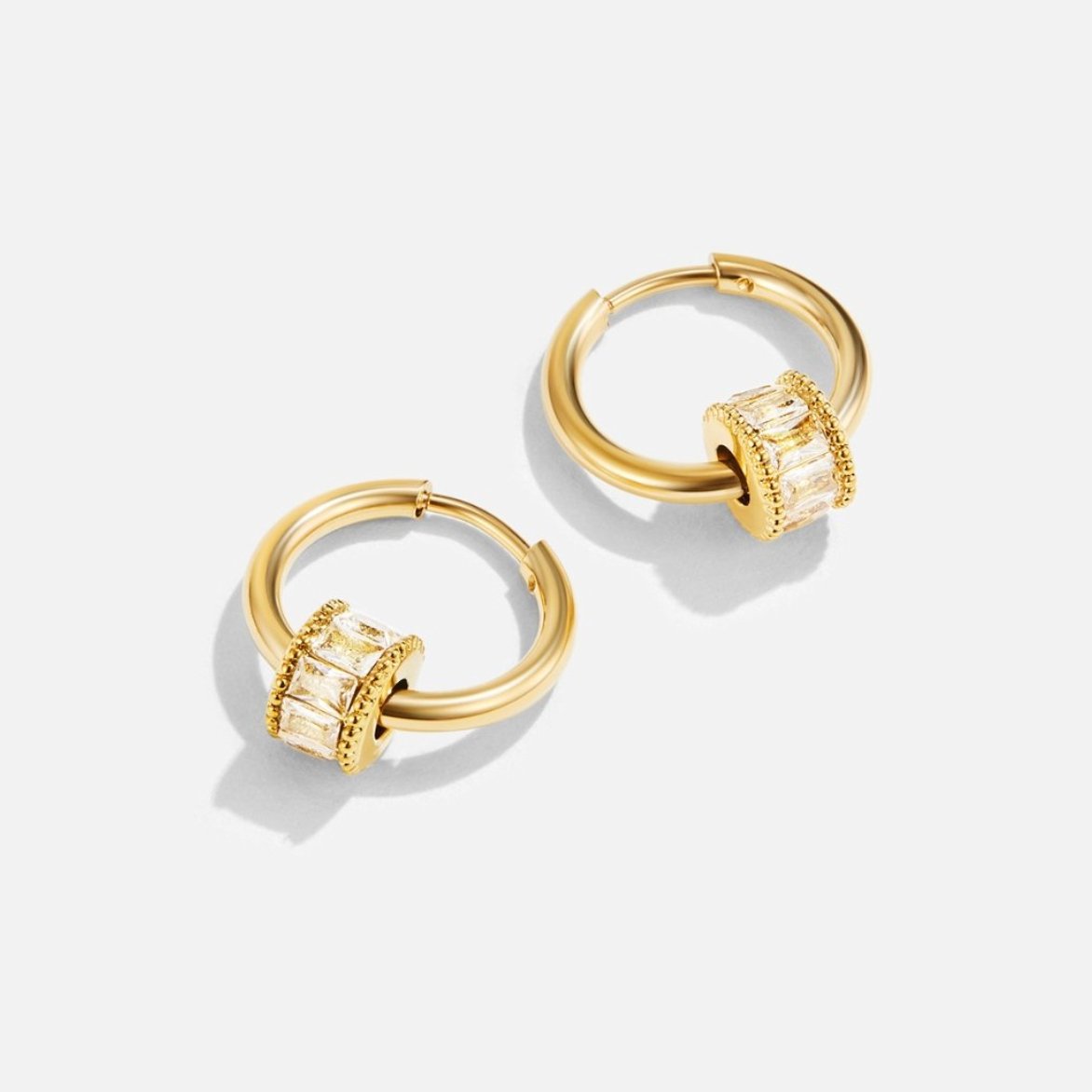 Gigi 18K Gold Set, pair of gold hoops with baguette-stone rings on white background