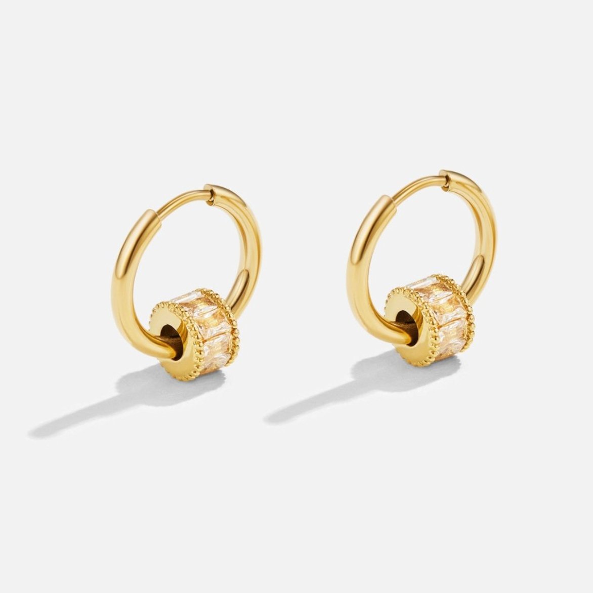 Gigi 18K Gold Set, pair of gold hoops with baguette-stone rings on white background