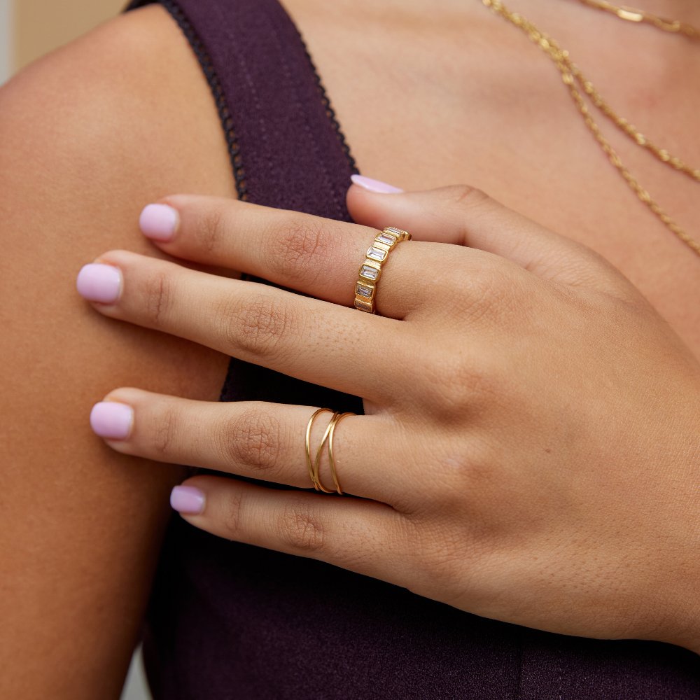 Gigi Square Crystal Ring, worn on a hand with pink nails and gold chain necklaces