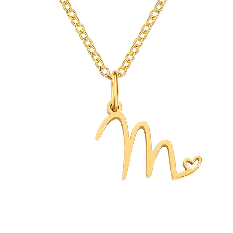 Gold Letter Heart Necklace, flat-lay on white, gold chain with script letter pendant