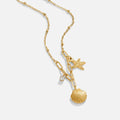 Golden Seashell & Starfish Necklace, laid flat on white, gold shell, starfish and crystal charms