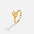 Golden Spiral Shell Ring, gold ring with a raised spiral shell on a textured band, on a plain background