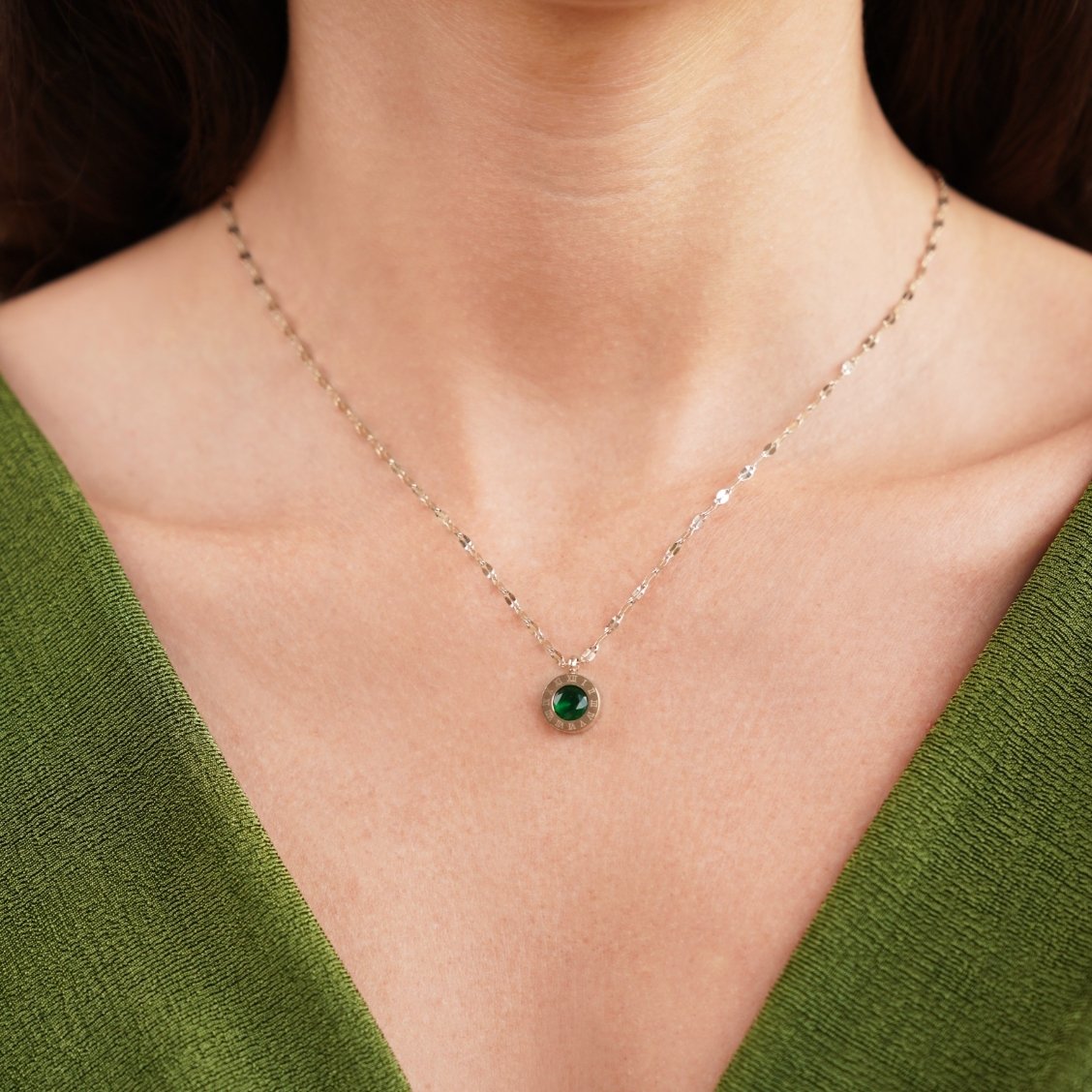 Green Crystal Athena Necklace, worn on a neck with a green top, round green stone pendant