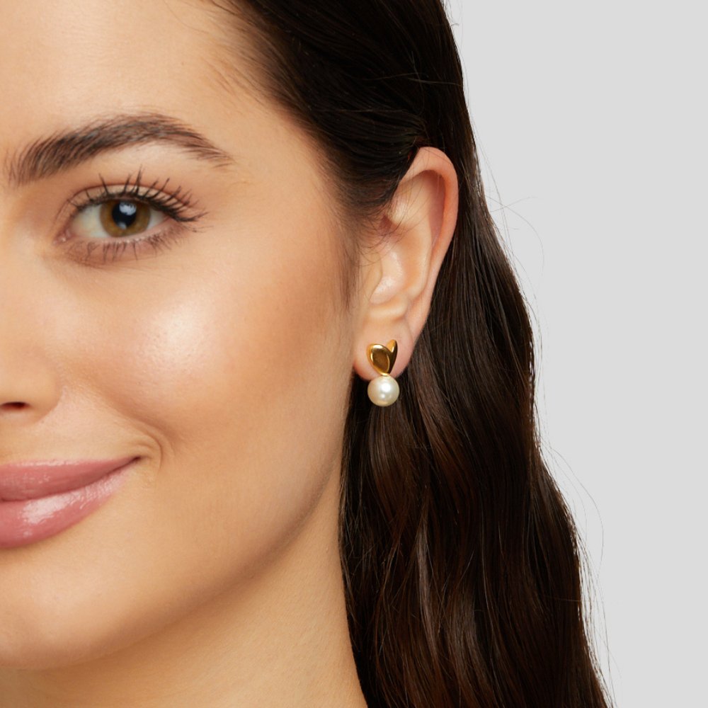 Heart & Pearl Earrings, worn on an ear, gold stud with a dangling white pearl