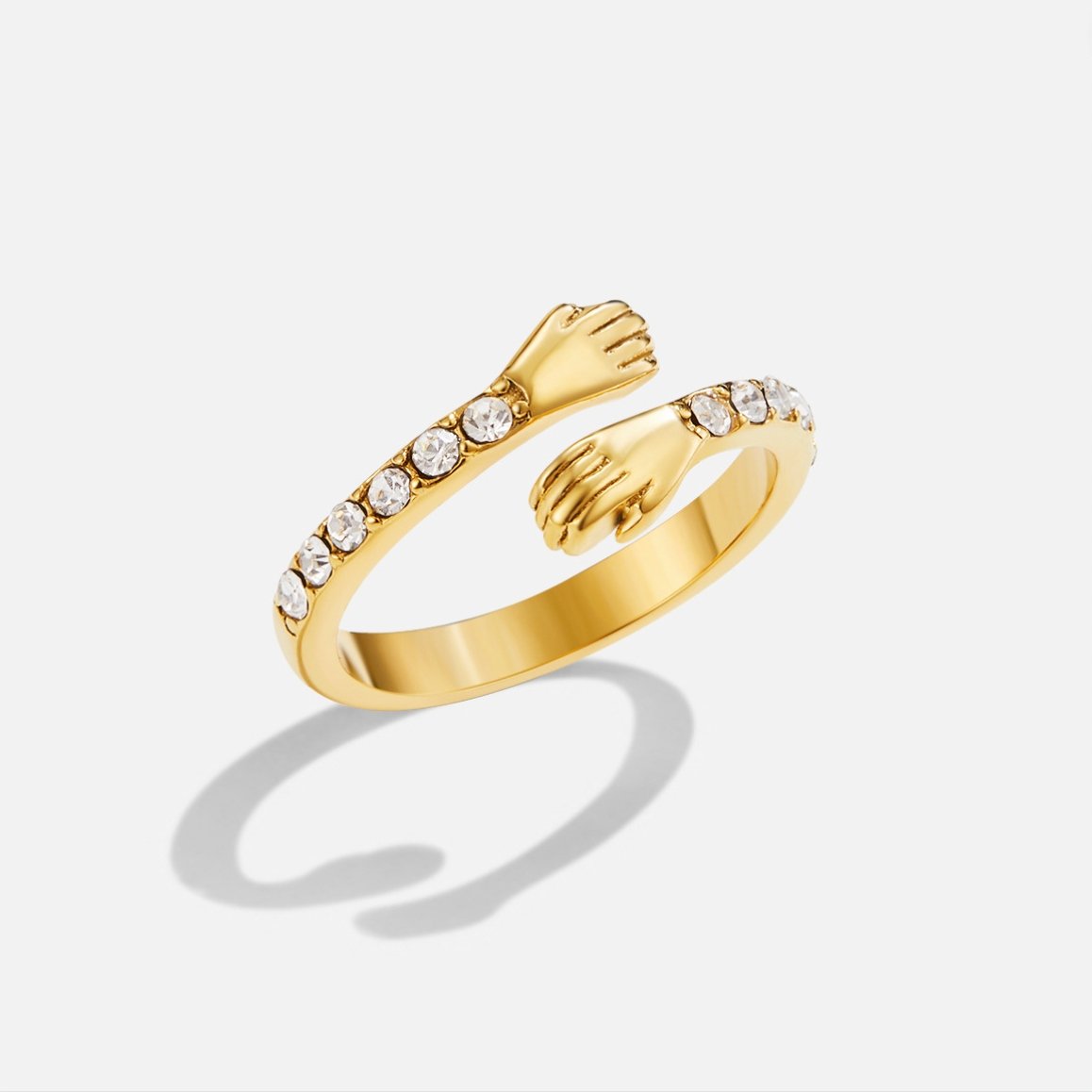 'Hug Me Forever' 18K Gold Ring, open gold ring with hands clasping and clear stones along one