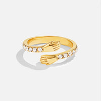 'Hug Me Forever' 18K Gold Ring, open-band ring with hand shapes meeting, set with clear stones