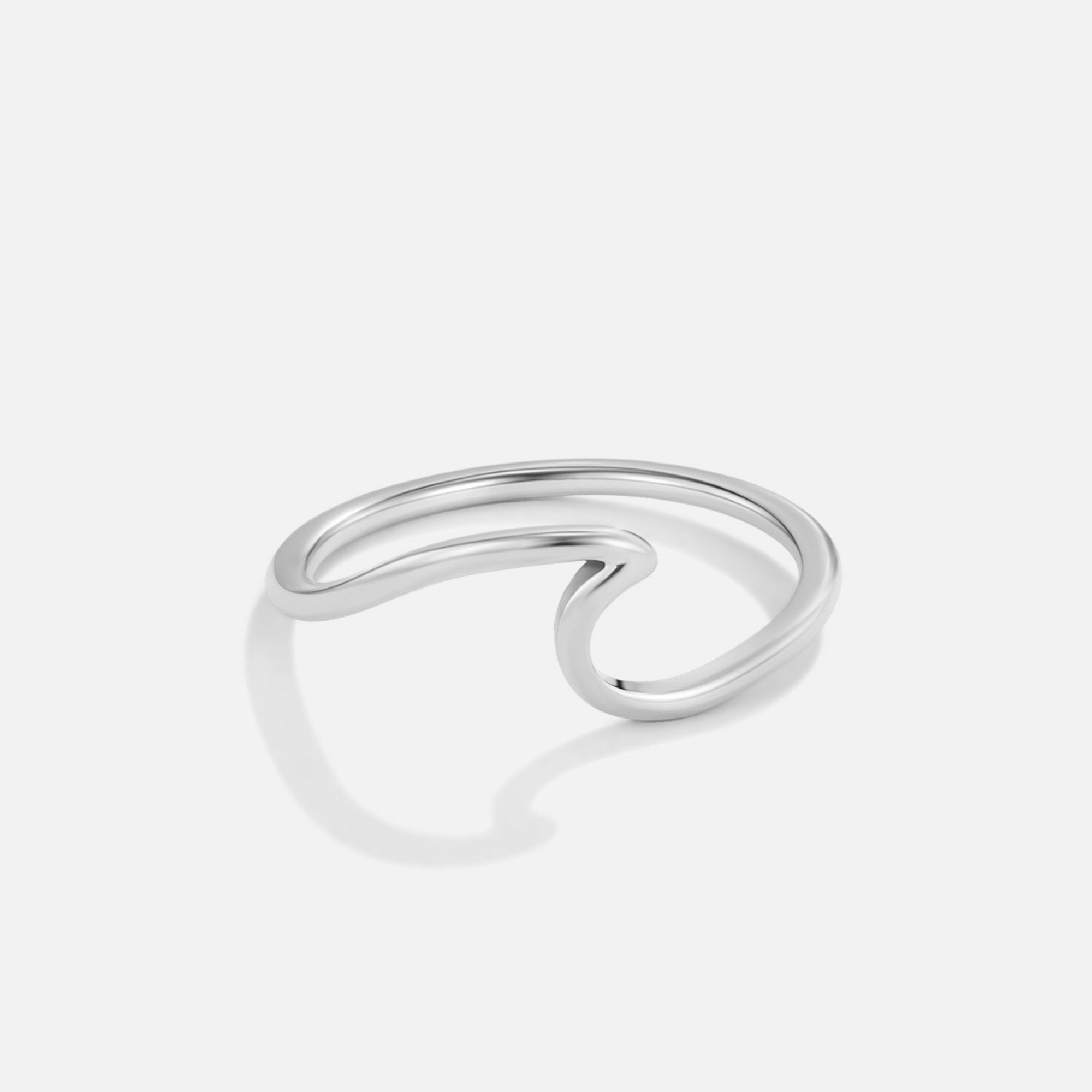 Imari Silver Wave Ring, polished silver ring lying flat on white, shaped like a wave