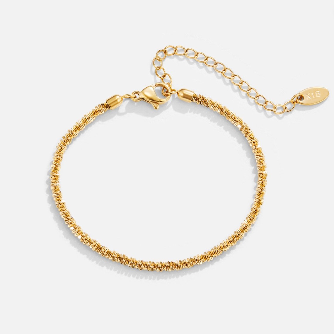 Kai 18K Gold Bracelet, flat lay of a textured gold bracelet with an extender chain