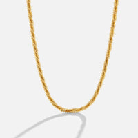 Kai 18K Gold Necklace, gold necklace draped against a plain white background, textured coil links