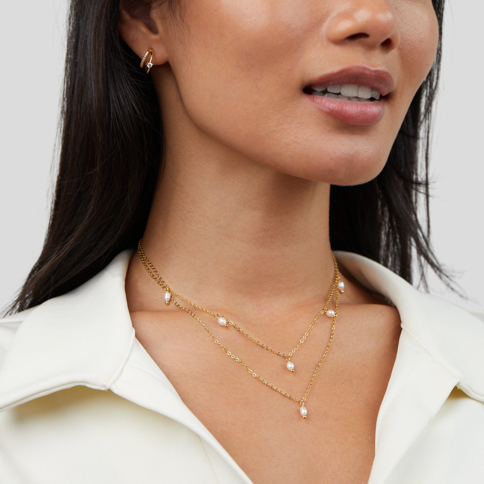 Kayla Pearl Drop Layered Necklace, worn layered on a neck in a white collared top