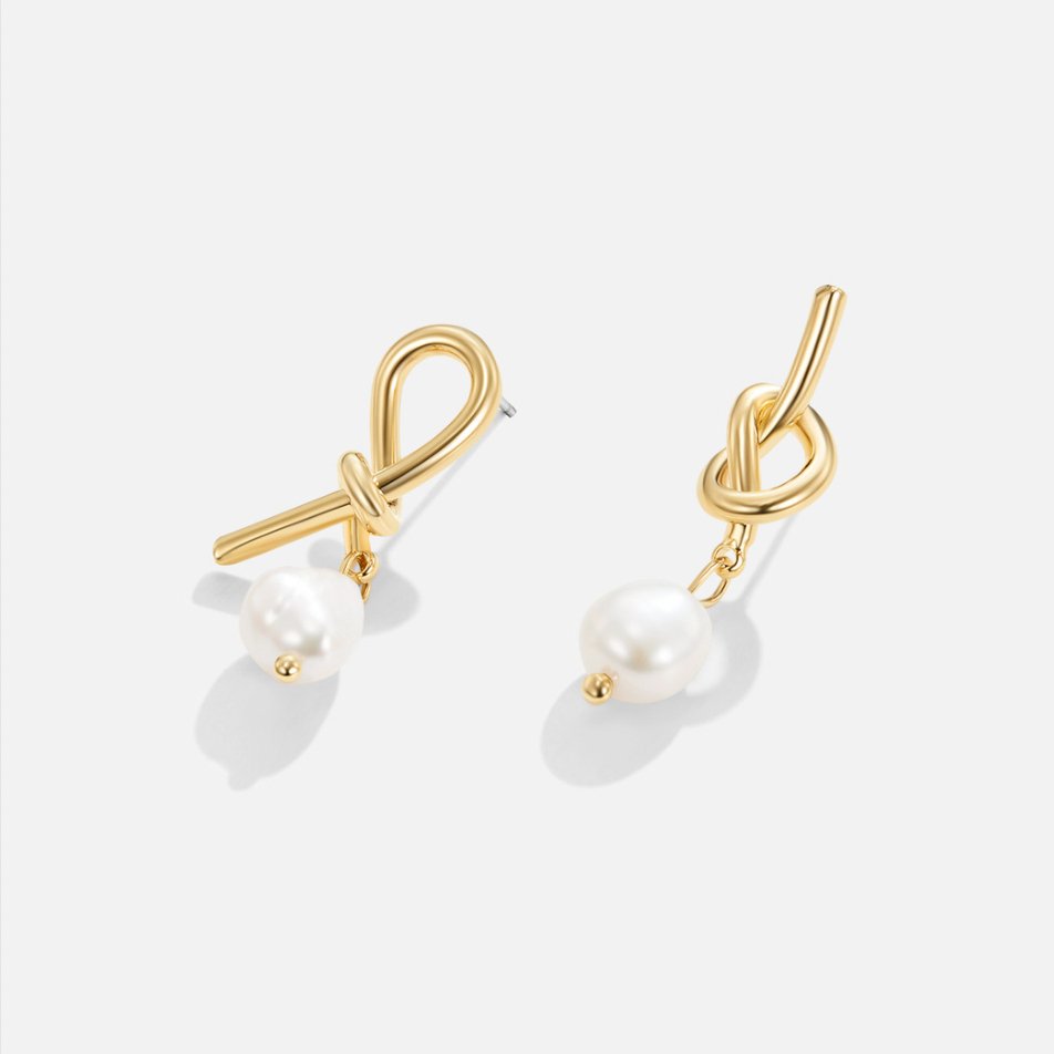 Knotted Gold & Freshwater Pearl Earrings, pair of gold knot earrings with hanging pearls on white