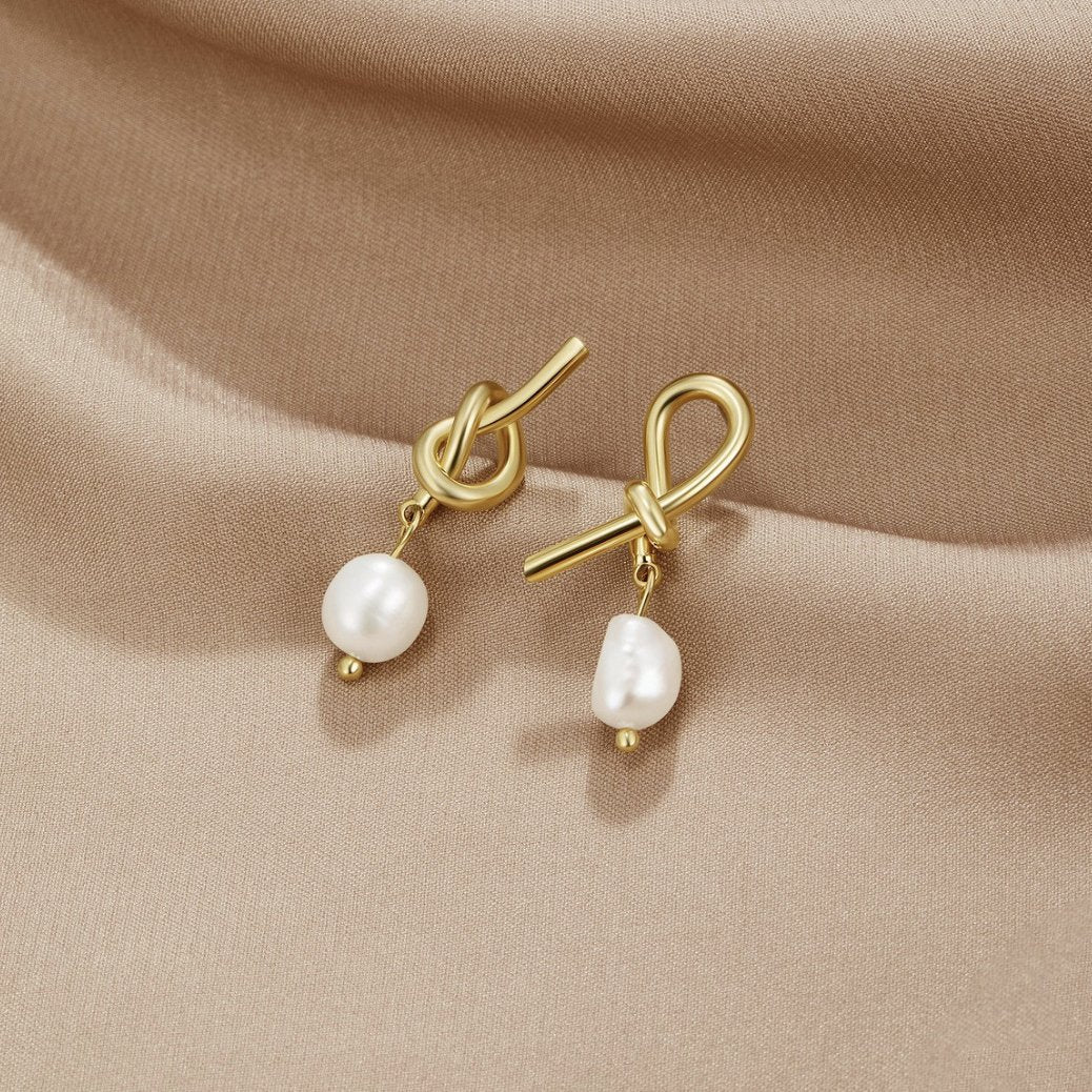 Knotted Gold & Freshwater Pearl Earrings, pair of knot-shaped gold earrings with pearl drops