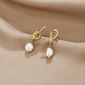 Knotted Gold & Freshwater Pearl Earrings, pair of knot-shaped gold earrings with pearl drops