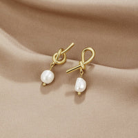 Knotted Gold & Freshwater Pearl Earrings, pair of knot-shaped gold earrings with pearl drops