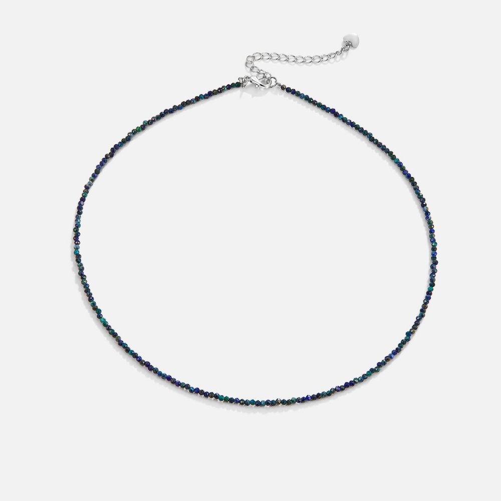Lapis Lazuli Beaded Stone Necklace, laid flat on a pale background, dark blue-green faceted
