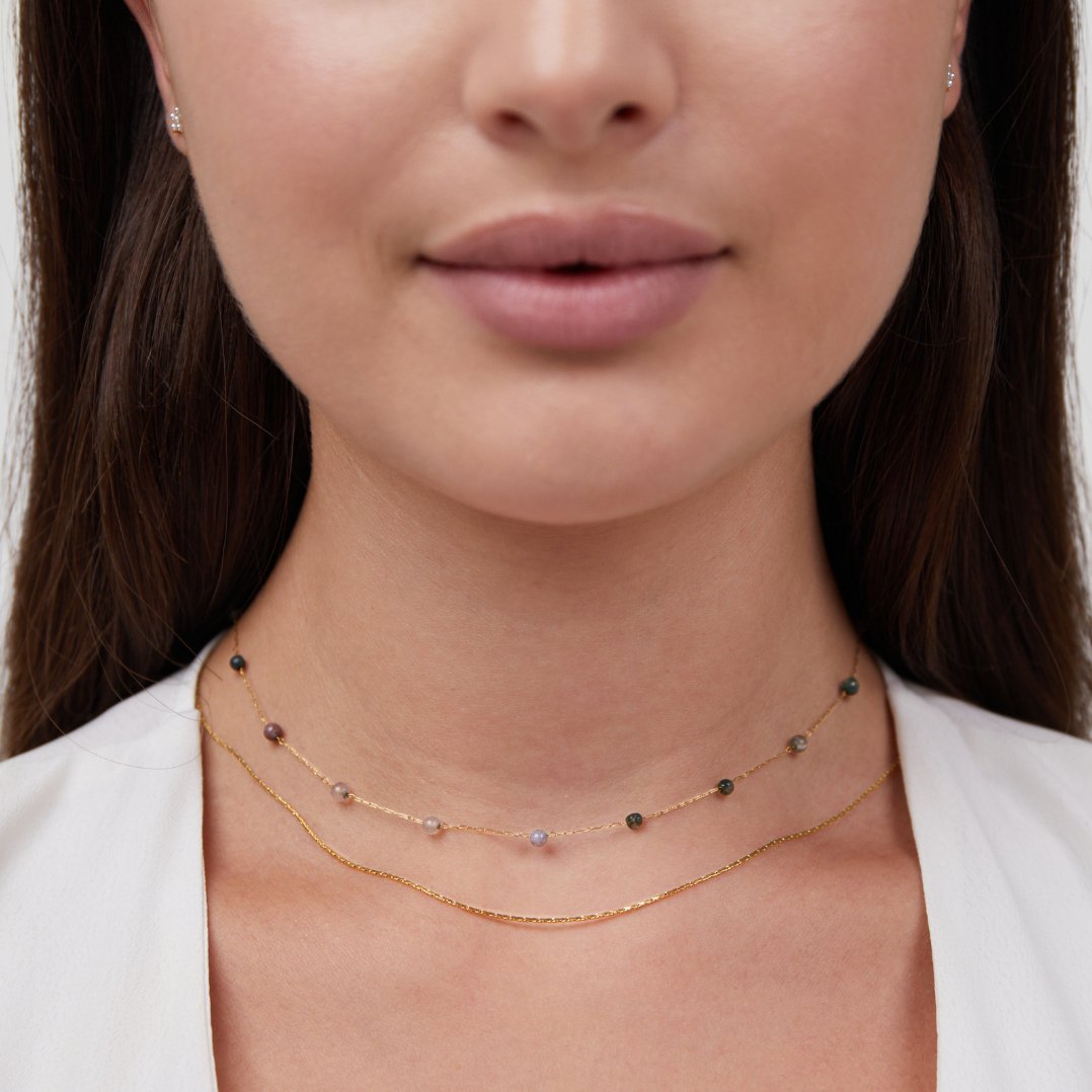 Layered Alana Gold & Stone Necklace, worn layered at the neck over a white top, with small
