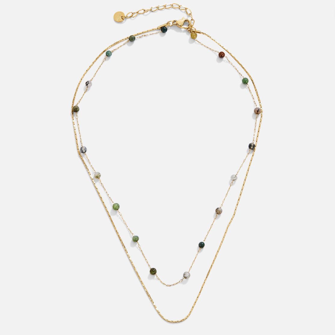 Layered Alana Gold & Stone Necklace, flat lay of a two-strand gold necklace with green and