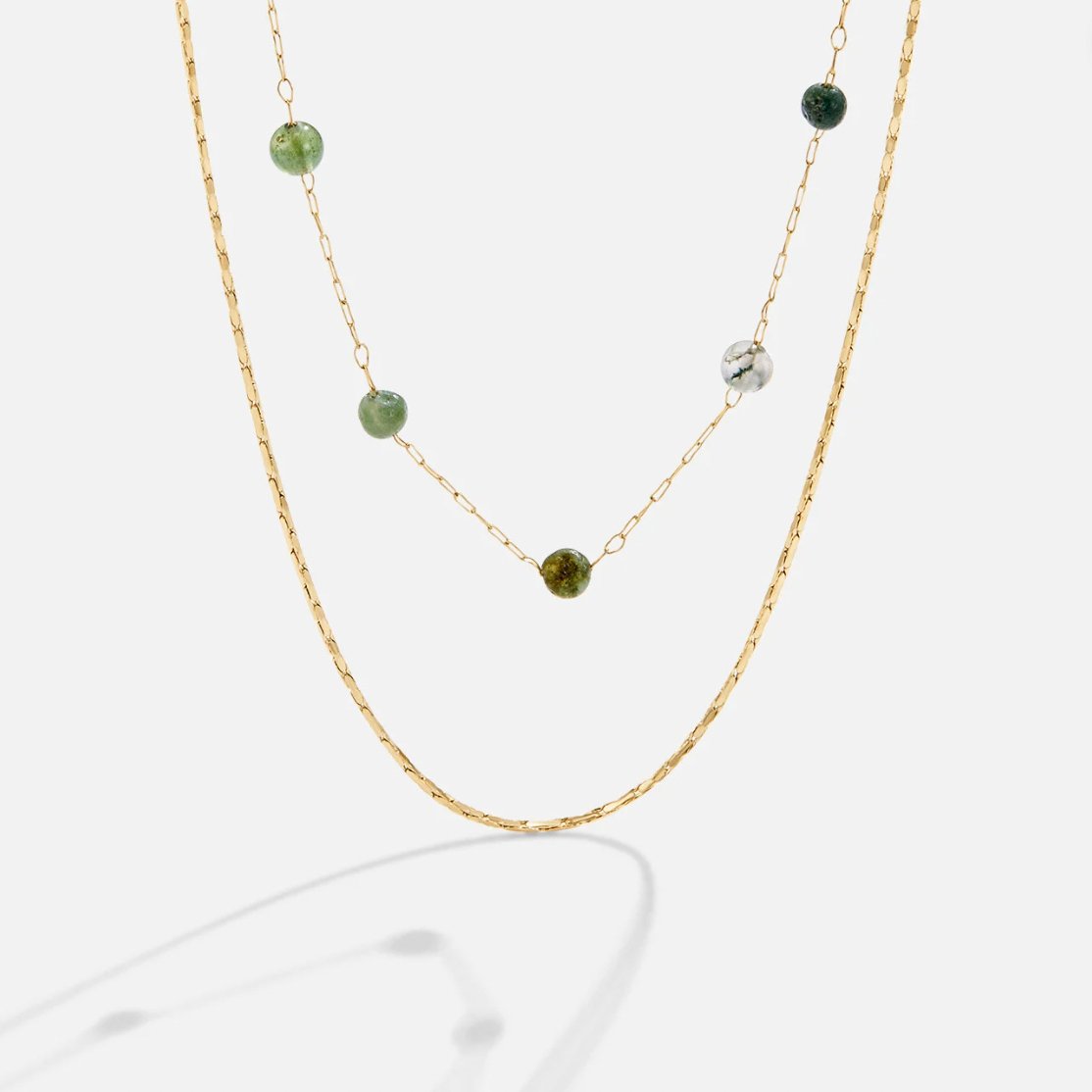 Layered Alana Gold & Stone Necklace, two gold necklaces layered, one with green stone beads