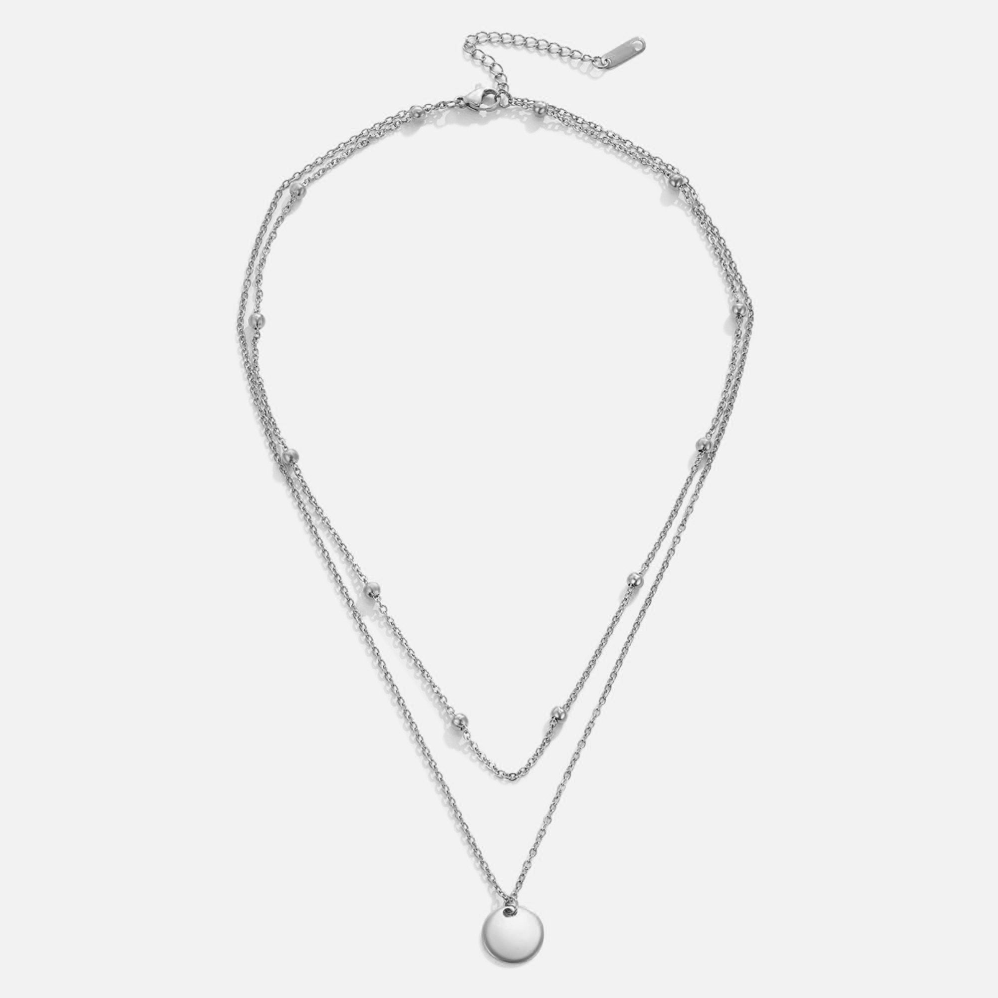 Layered Disc Necklace Silver, flat lay of a two-strand chain with a round disc pendant