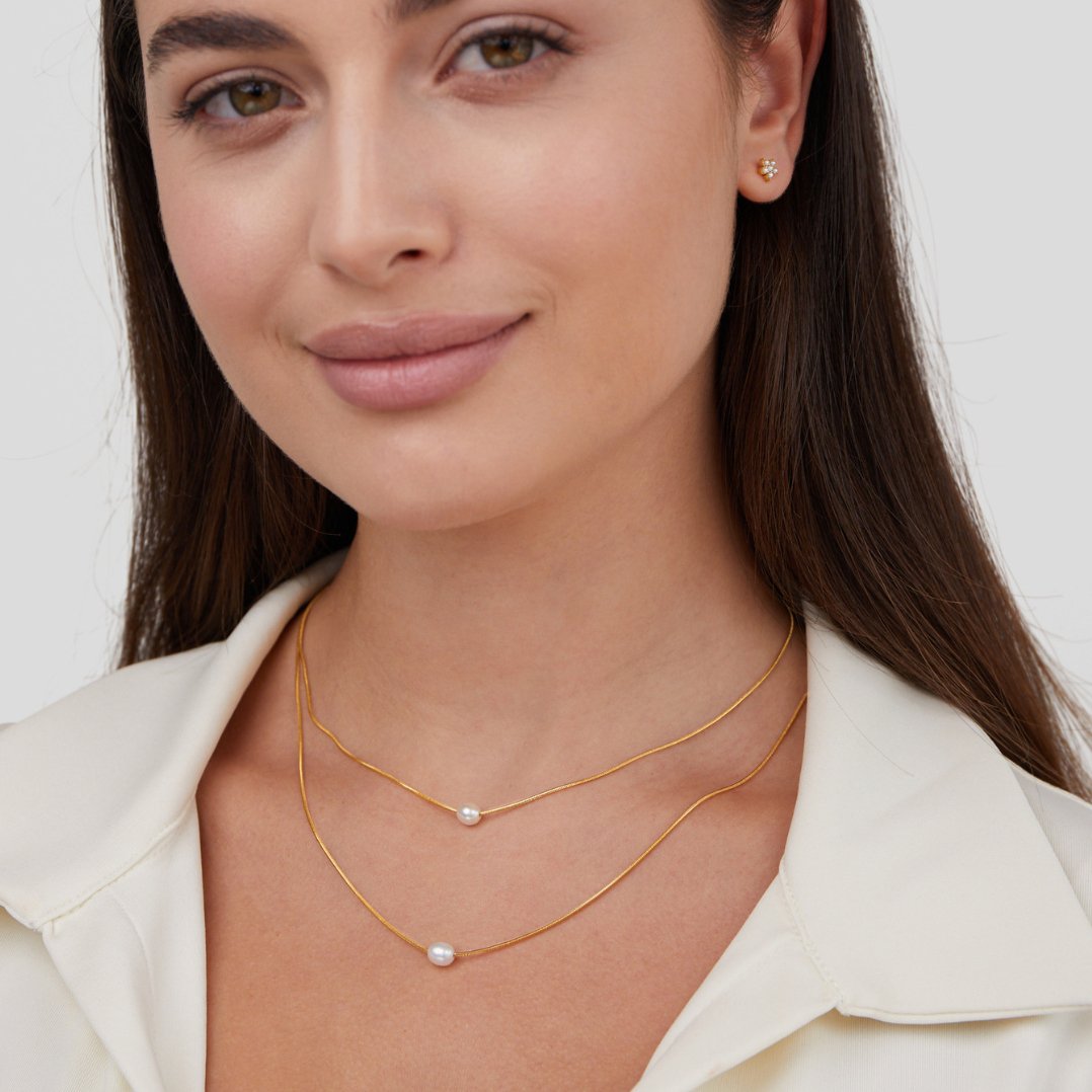 Layered Freshwater Pearl Necklace, worn layered on a model in a cream collared top