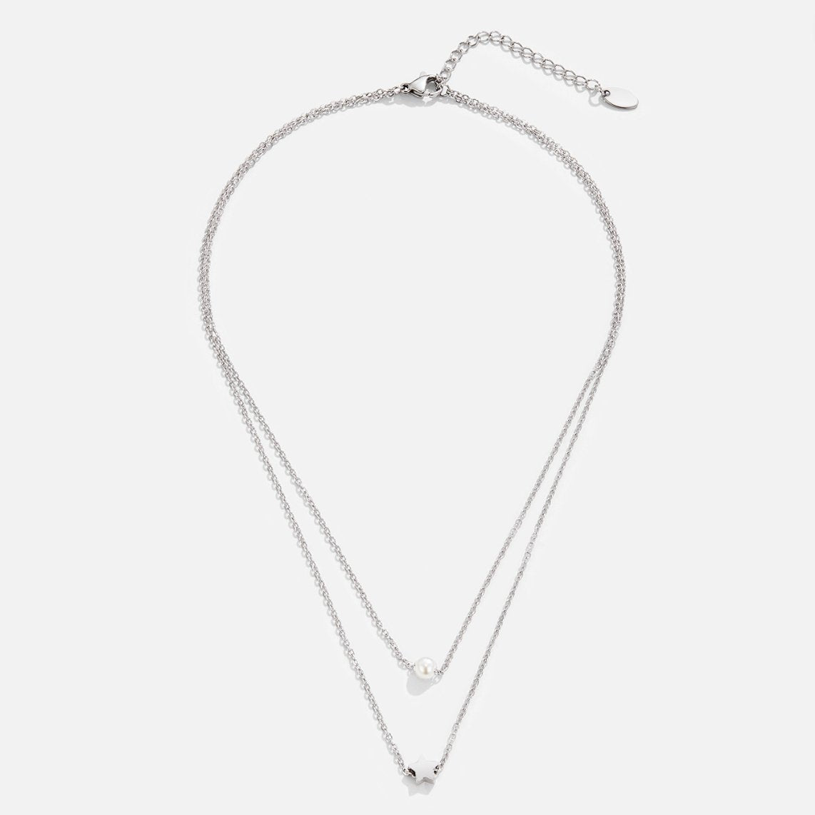 Layered Silver Star & Pearl Necklace, flat lay of two silver chains, pearl and star charms on white