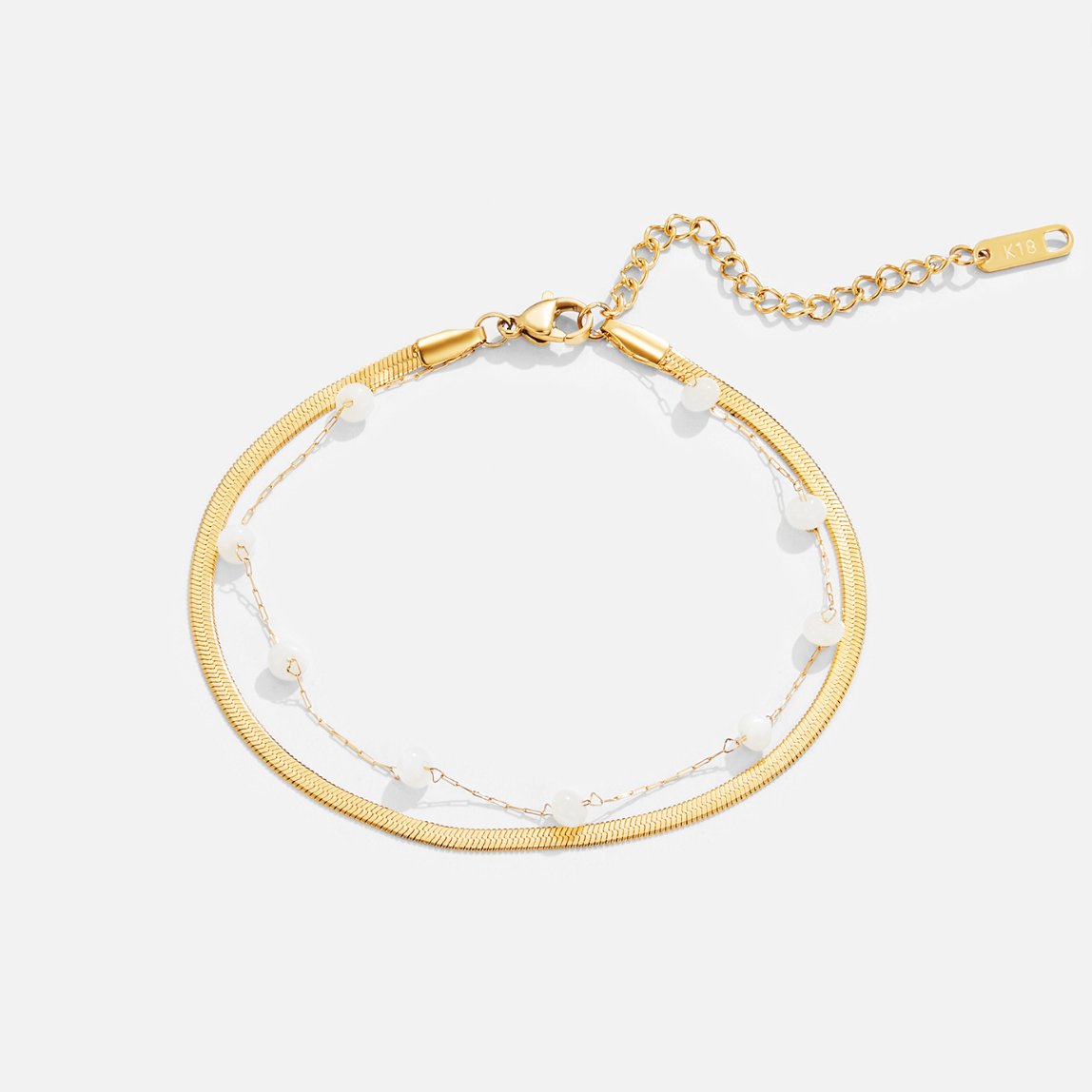 Layered Snake Chain Gold Anklet, flat lay of a gold bracelet with pearl beads and extender chain