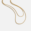 Leona Layered Gold Necklace, two gold chains draped in loose curves on white, one twisted and