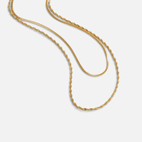 Leona Layered Gold Necklace, two gold chains draped in loose curves on white, one twisted and