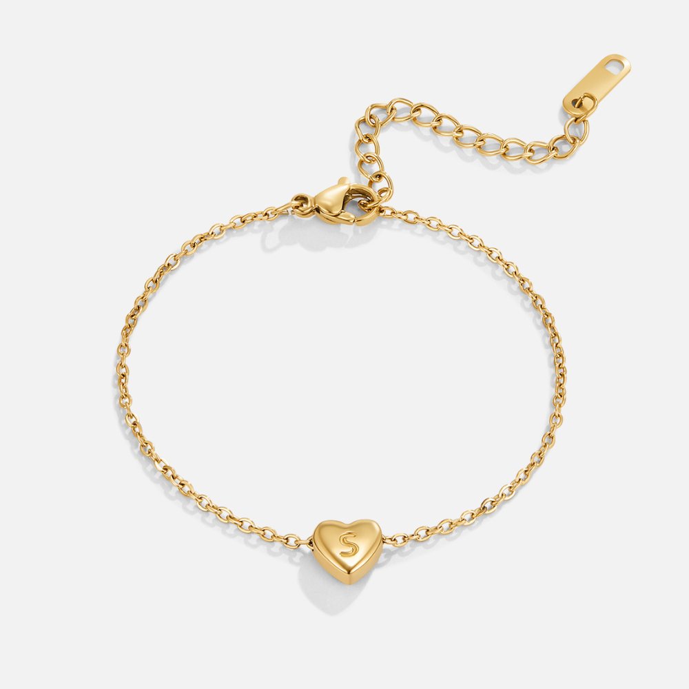 Letter Heart Bracelet, gold chain bracelet laid flat, with a heart charm engraved with the letter S