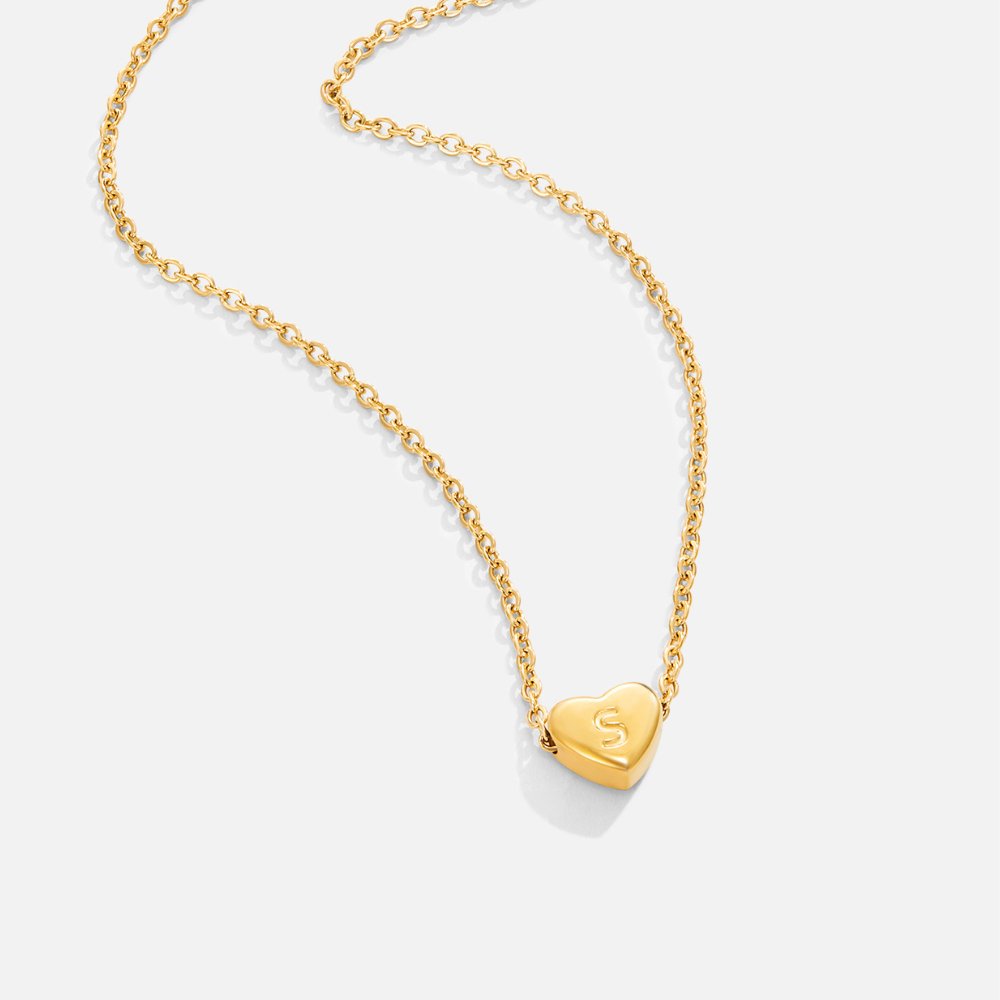 Letter Heart Necklace, gold chain necklace on white with a heart pendant engraved with the letter S