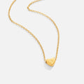 Letter Heart Necklace, gold chain necklace on white with a heart pendant engraved with the letter S