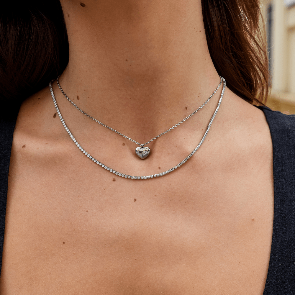 Cordelia Silver Crystal Necklace, worn on a neck layered with a silver tennis chain