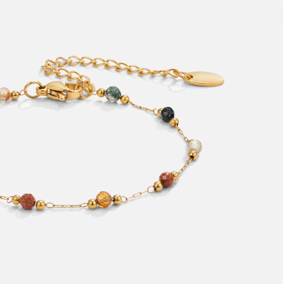 Lulu Beaded Stone Bracelet, gold bracelet with multicoloured stone beads, lying flat on white