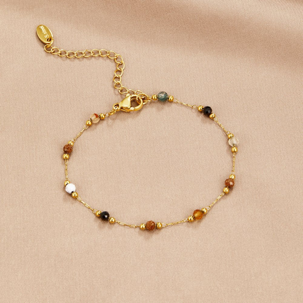 Lulu Beaded Stone Bracelet, flat lay on beige satin, gold chain with mixed gemstone beads