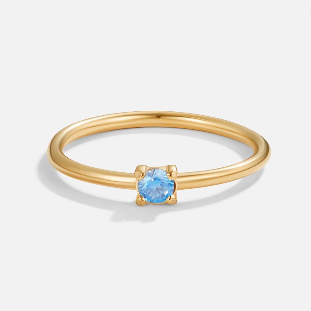 March Birthstone 18K Gold Ring, thin gold band with a small blue stone in four prongs